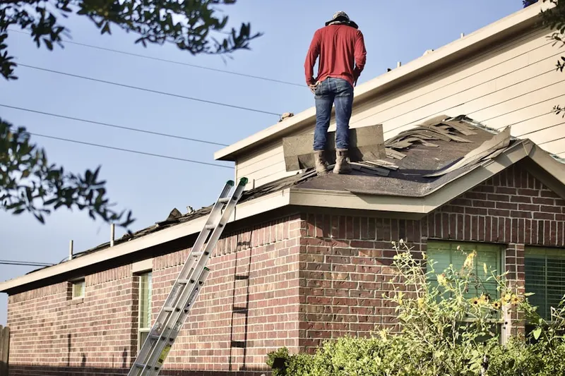 Professional roofer working on a residential roof in Manor Woods